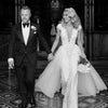 real bride with wedding headpiece walking hand in hand with groom